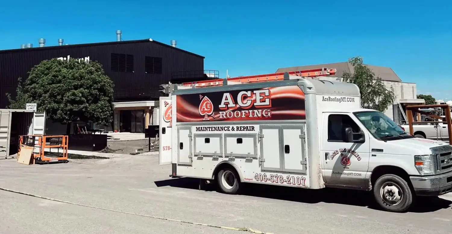 Ace Roofing maintenance and repair service truck parked outside a commercial building